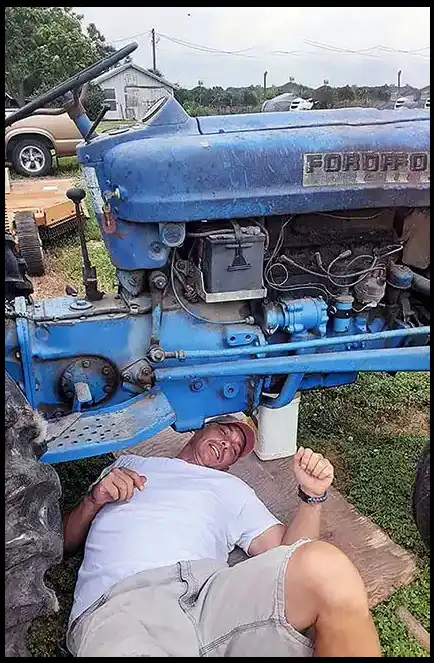 CEO and Veteran David Haave working on the blue tractor in the Spring Break to Mars book Tipton MO USA -- David Haave